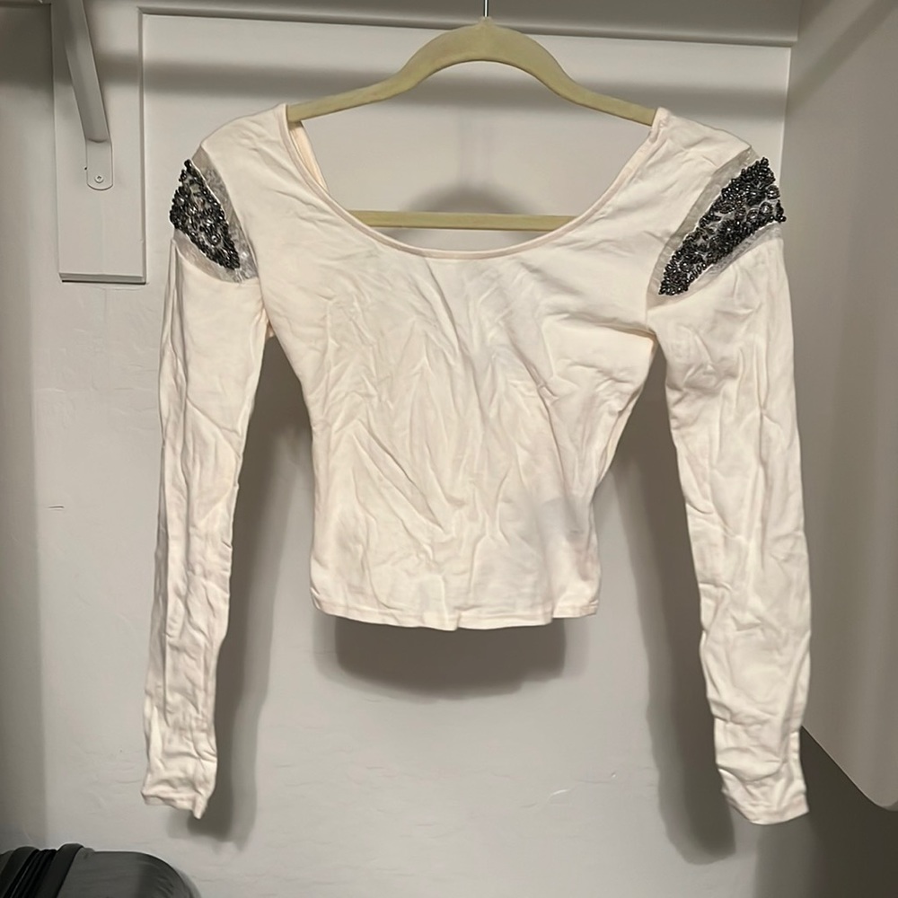 Cream crop top that is sea through.